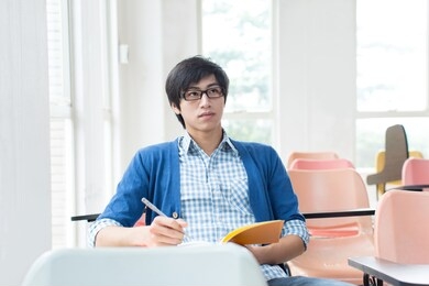 asian college student studying in classroom