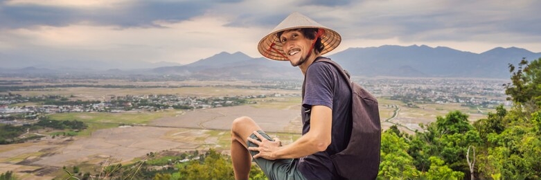 young man tourist in a traditional vietnamese hat travels to vietnam 