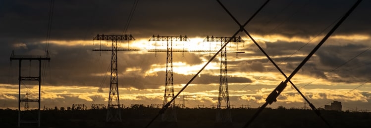 silhouette high voltage electric tower on sunset time and sky on sunset time background. big high voltage pylons