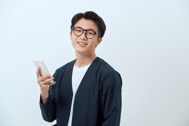 young handsome asian man using mobile phone
