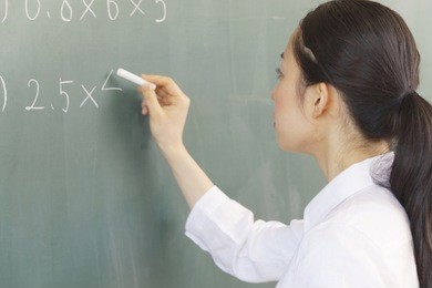 female teachers to write a problem on the blackboard