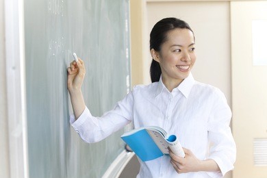 female teachers to write a problem on the blackboard