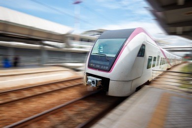train approaching railway station with motion blur.