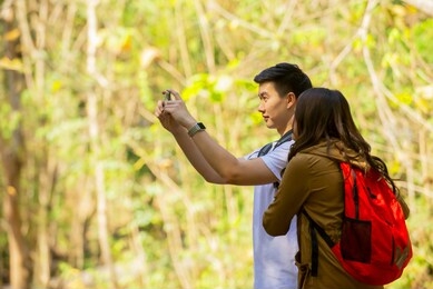 asian traveler  couple take photo by smartphone  at natural park enjoy view  , travel  vacation technology holiday healthy lifestyle  concept 
