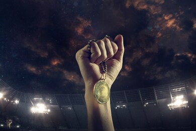 champion. award of victory, male hands tightening the golden medal of winners against cloudy dark sky. sport, competition, championship, winning, achieving the goal. prize for success and honor.