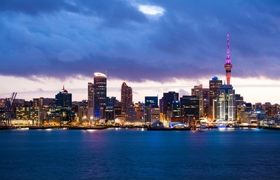 skyline photo of the biggest city in the new zealand, auckland. the photo was taken after sunset across the bay