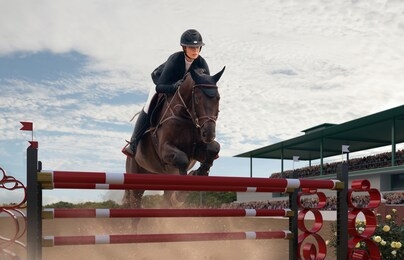 equestrian sport. young girl rides on horse on championship.