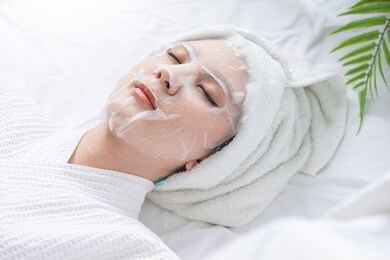 beautiful woman in the spa salon, treatment hyperpigmentation and melasma on face by serum mask, facial rejuvenation procedure.