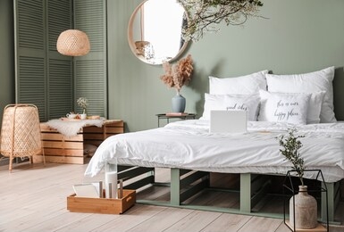 interior of beautiful modern bedroom with spring flowers