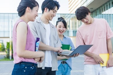 portrait of a college student standing in the green