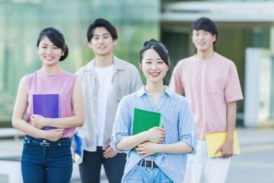 portrait of a college student standing in the green