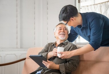 cheerful senior asian father and middle aged son in living room, happiness asian family concepts