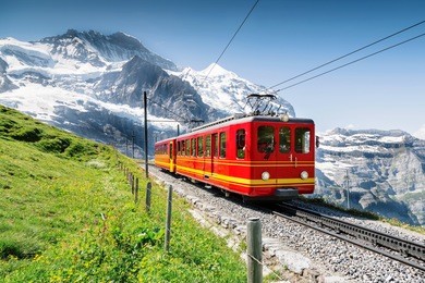 famous train with jungfrau mountain on sunny day 