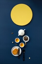 flat lay mid autumn festival snack and drink, moon cake and tea set on blue background still life image. 