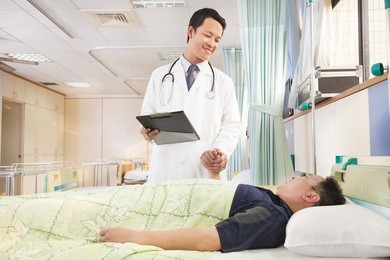 smiling  doctor holding patient hand to encourage him
