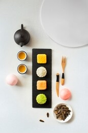 flat lay mid autumn festival snack and drink, moon cake and tea set on white textured  background still life image. 