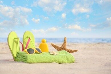 different stylish beach objects and starfish on sand near sea