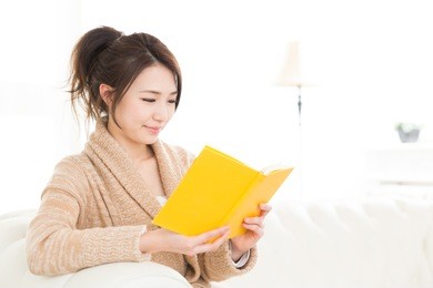 young attractive asian woman who reads a book