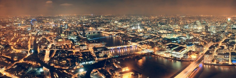 london aerial view panorama at night with urban architectures and bridges.