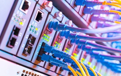 fiber optic cables connected to an optic ports and network cables connected to ethernet ports