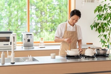 young asian man cooking at kitchen