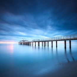 modern steel pier in a cold atmosphere long exposure photography in lido camaiore, versilia, tuscany, italy, europe