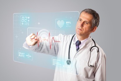 middle aged doctor standing and pressing modern medical type of button