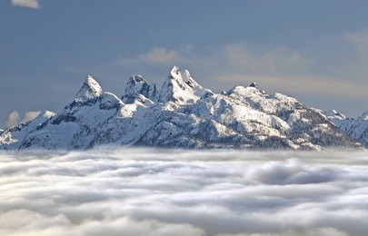 pilot mountains above clouds - in the coast mountain range, british columbia, canada