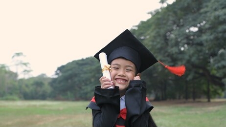 educational concepts. asian children are happy on their diploma, graduation day.