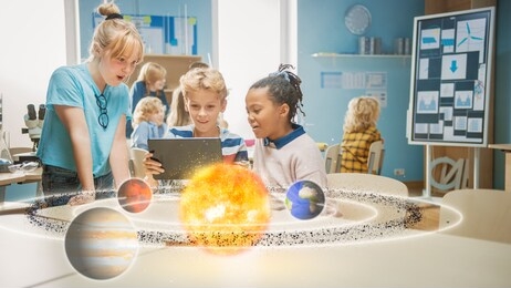 three diverse school children in science class use digital tablet computer with augmented reality software, looking at educational 3d animation of solar system. vfx, special effects render