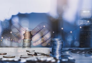 double exposure of  trading graph and hand stack sterling coin with blurry building in london at night, the image can us for business and financial investment background concept