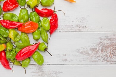several whole paper lantern habanero peppers on the left with blank area on the right for text.