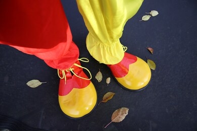 clown boots close-up on a black background.halloween holiday. clothing and accessories for halloween party.