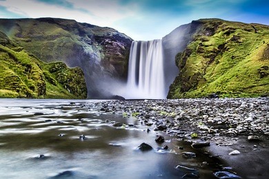 long exposure of famous skogafoss waterfall in iceland at dusk