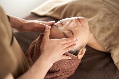 japanese woman receiving a facial massage at an aesthetic salon
