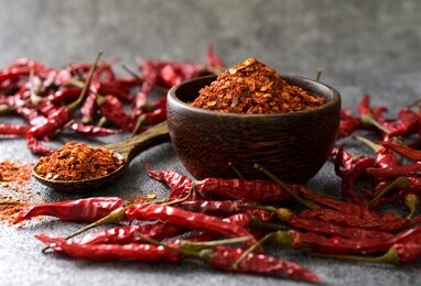 cayenne pepper (ground chili) and dried chili on a black background,copy space.