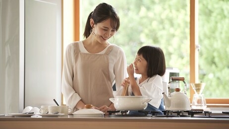 girl and mother are cooking, father is teleworking