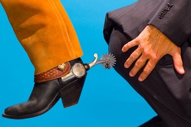 cowboy spurring business mans butt