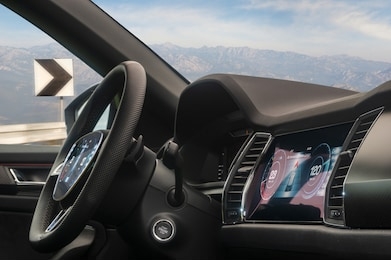 interior of a modern car with displays on the dashboard and steering wheel with the possibility of autonomous driving