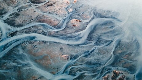 a glacial rivers from above. aerial photograph of the river streams from icelandic glaciers. beautiful art of the mother nature created in iceland. wallpaper background high quality photo