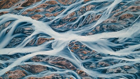 a glacial rivers from above. aerial photograph of the river streams from icelandic glaciers. beautiful art of the mother nature created in iceland. wallpaper background high quality photo