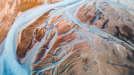 a glacial rivers from above. aerial photograph of the river streams from icelandic glaciers. beautiful art of the mother nature created in iceland. wallpaper background high quality photo