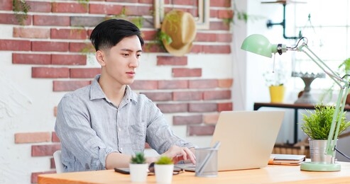 telework concept - asian man use computer to work and has a video meeting at home