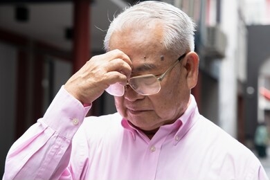 sick asian senior man suffering from sinusitis headache; health and sickness concept