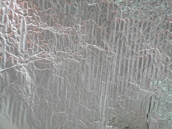 silver rough wrinkle foil texture. aluminium foil texture background. metal plate