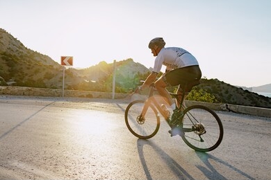 cycling sport athlete man riding on coastal road