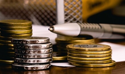 real currency, money from brazil. a group of brazilian banknotes and coins on a table.