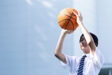 junior high school student playing basketball