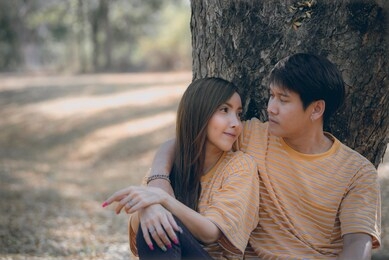 portrait of young asian couple in love  in the forest,thailand people happy to be together,valentine day concept