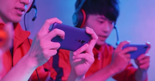 close up of team of asian teenage cyber sport gamers play mobile game by 5g smartphone on esport tournament